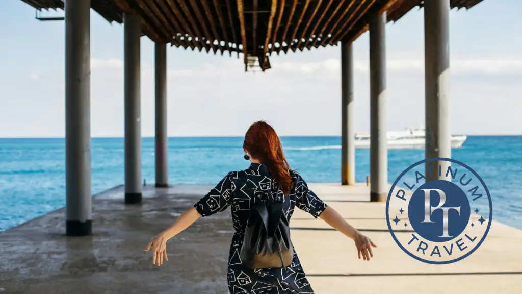 Woman Walking under Pier. Book this trip with Platinum Travel.